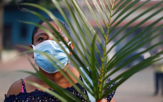 A woman attends a Palm Sunday procession in Nahuizalco, El Salvador, April 5, 2020. (CNS/Reuters/Jose Cabezas)